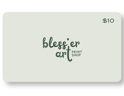A $10 gift card for Bless'er Art Print Shop with a pale sage green background and dark green logo text, shown on a white background with a soft drop shadow.